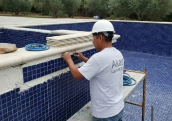 Swimming pool blue mosaic tiling installation Swimming pool blue mosaic tiling installation